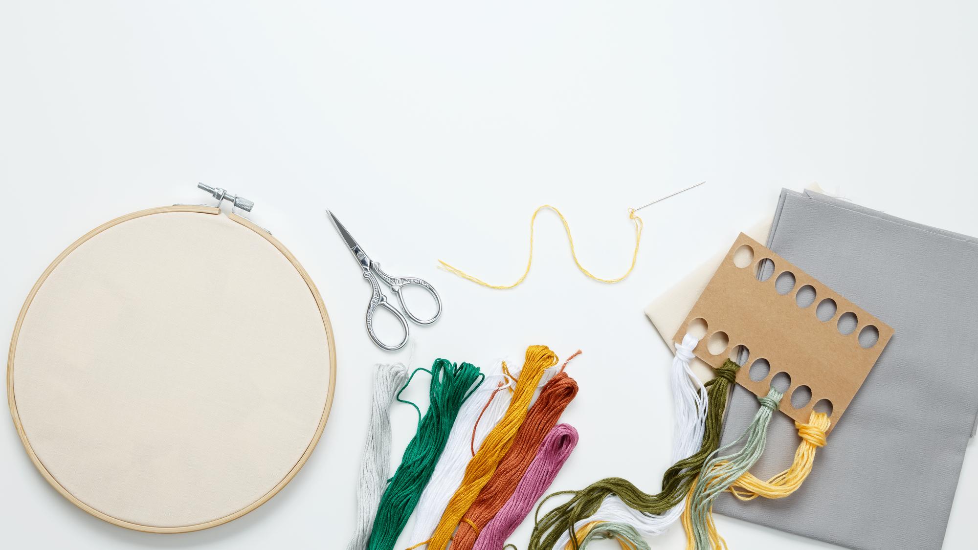 Series of embroidered patches laid out on craft table