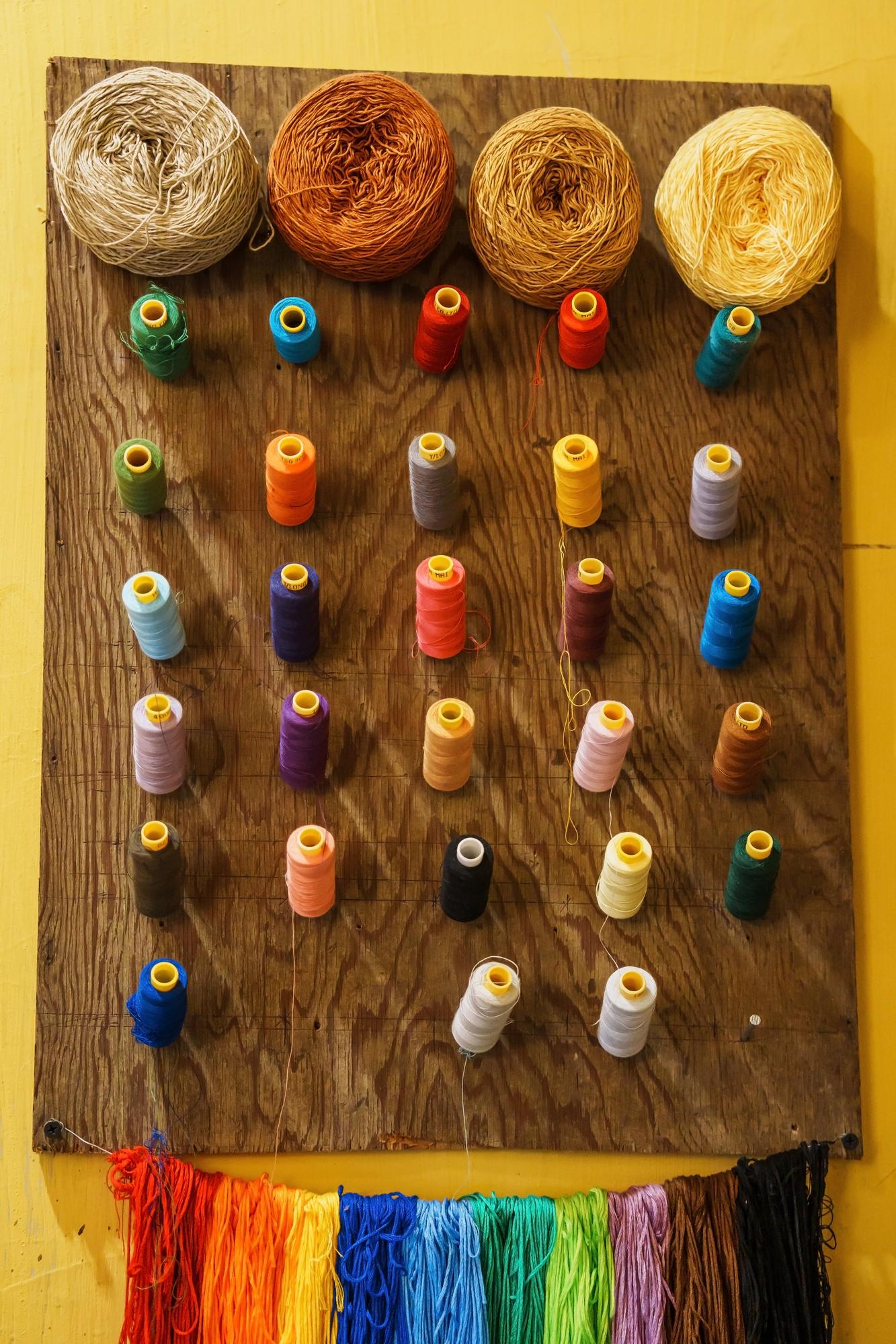 Assorted embroidered samples laid out for pricing examples